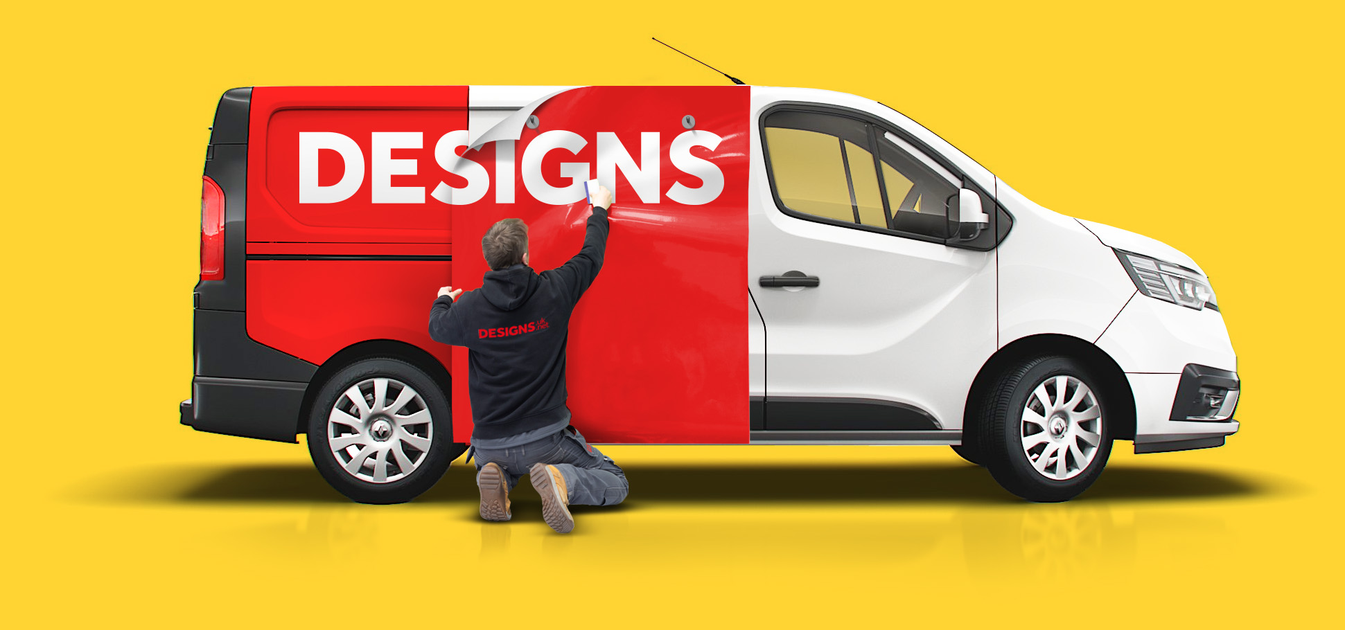 Designs employee fitting custom vehicle graphic.
