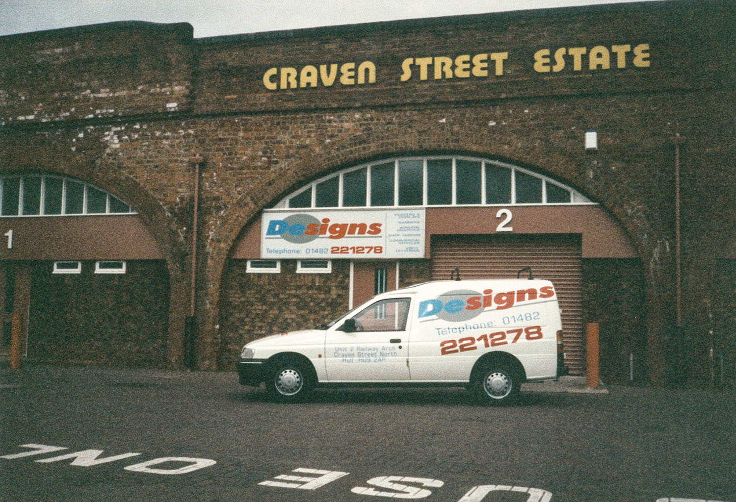 Photo of Designs office with a company car outside.